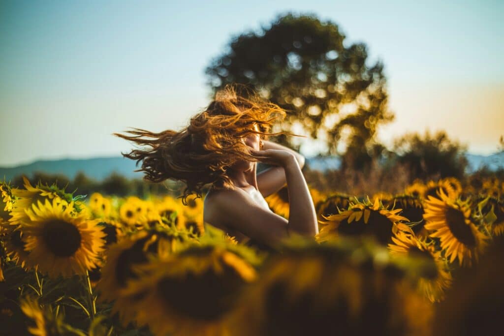 A woman in a field of sunflowers
