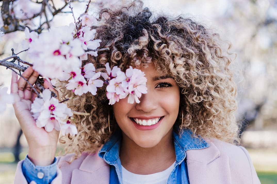Smiling,Hispanic,Woman,With,Eyes,Closed,In,Park,Enjoying,Sunny